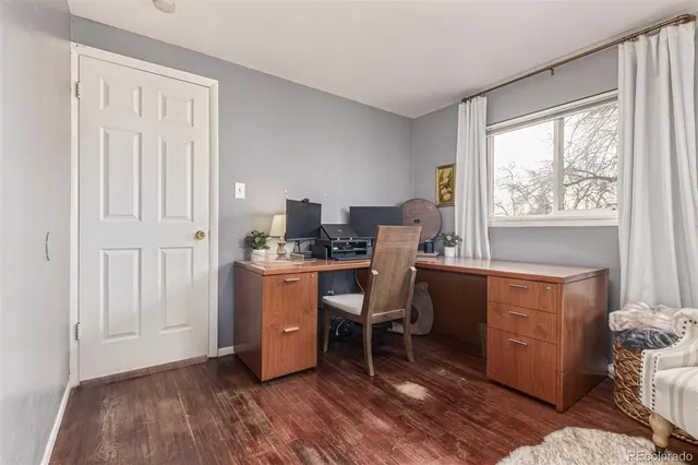 a room with furniture a window and wooden floor