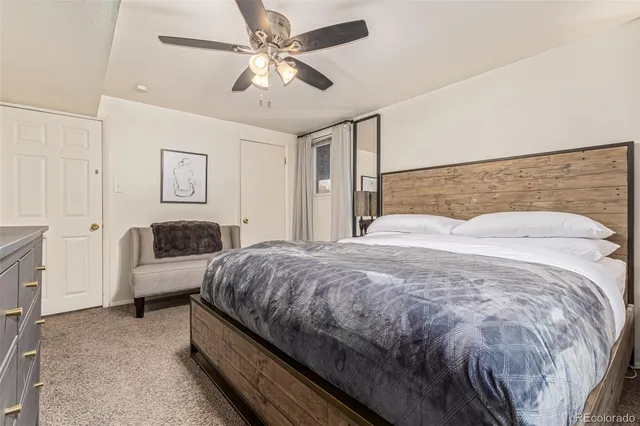 a bedroom with a bed couch and window