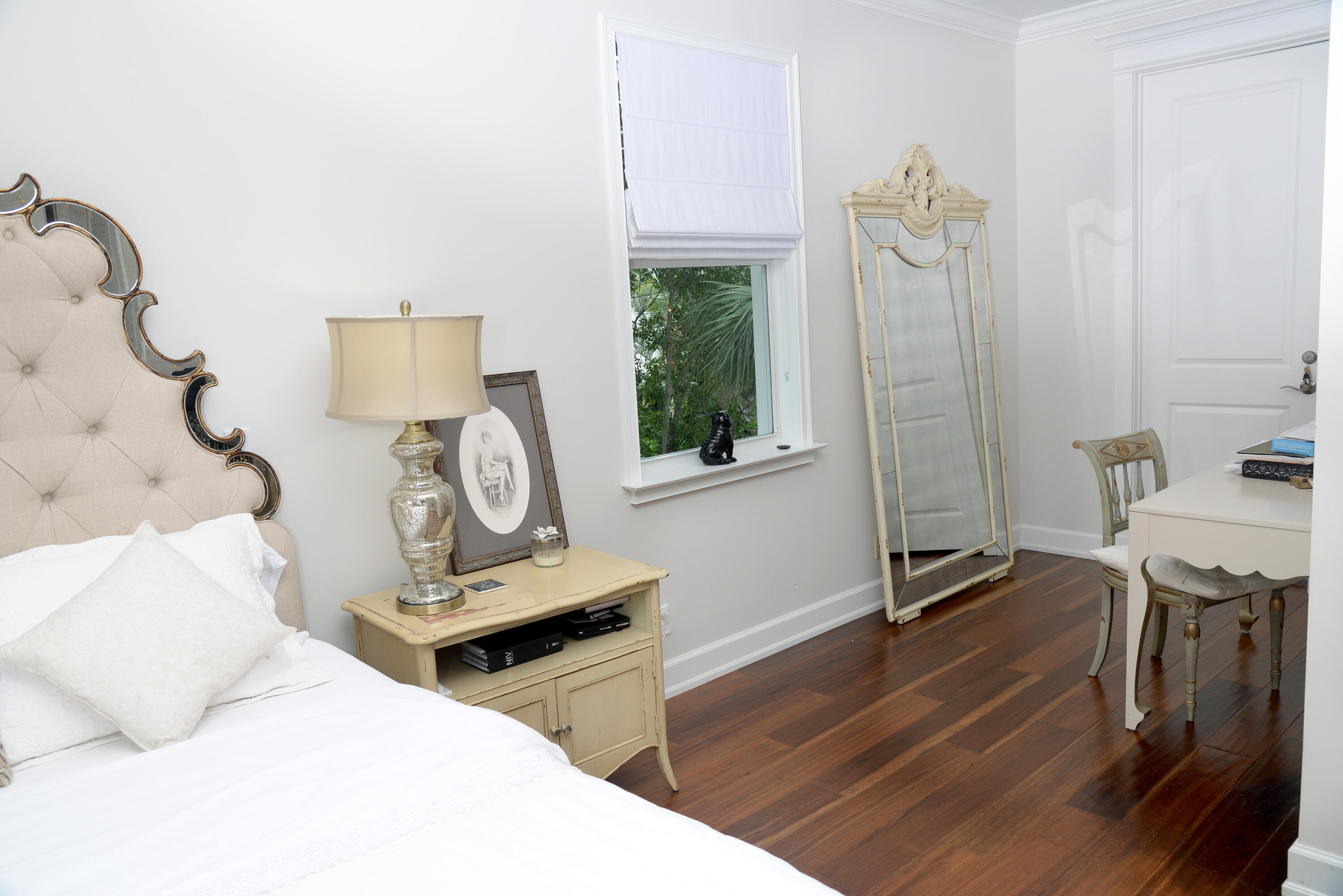 207 Killane Drive Jupiter, FL 33458 - Photo 42 of 59 a bedroom with a bed and a chandelier