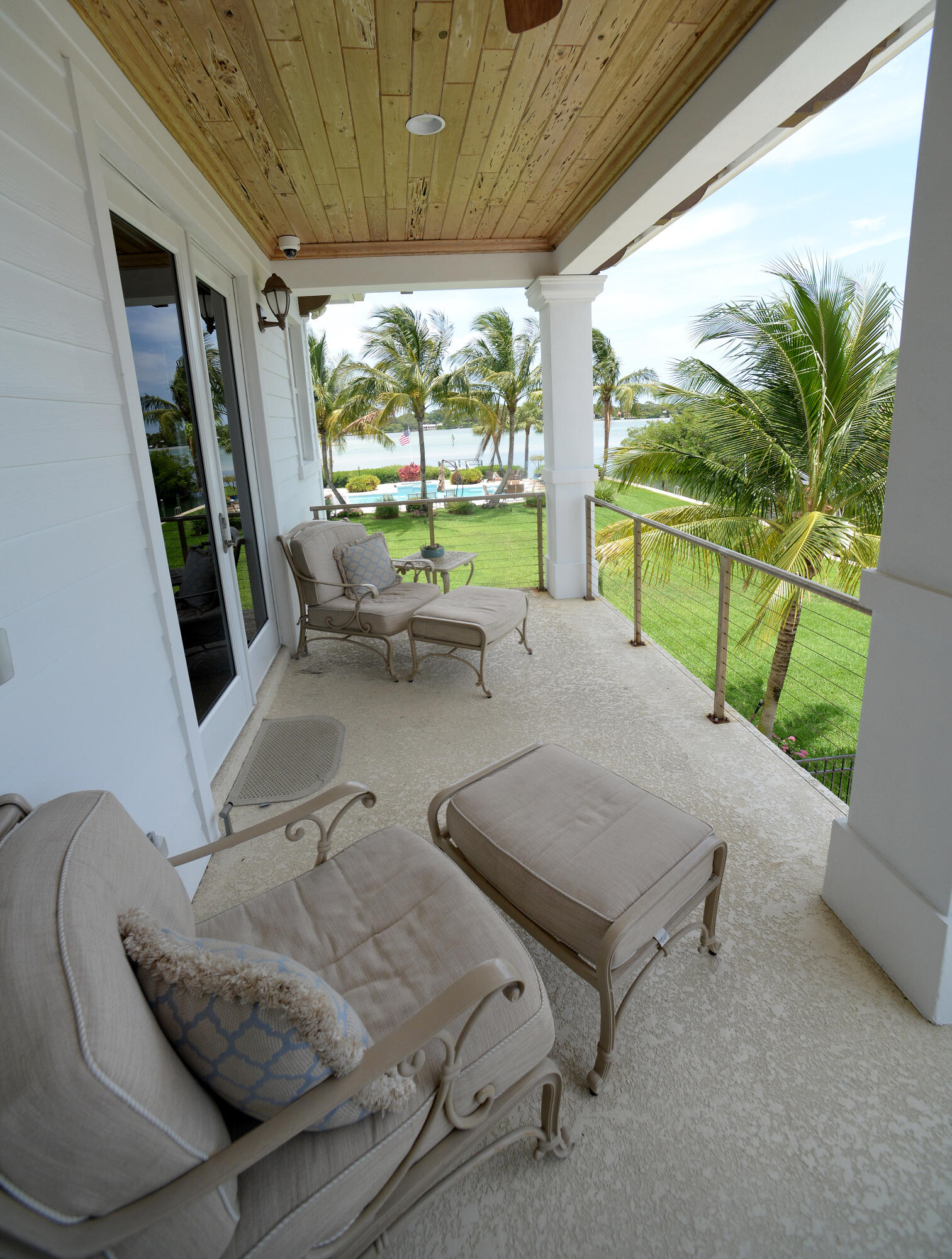 207 Killane Drive Jupiter, FL 33458 - Photo 52 of 59 a balcony with furniture and a garden
