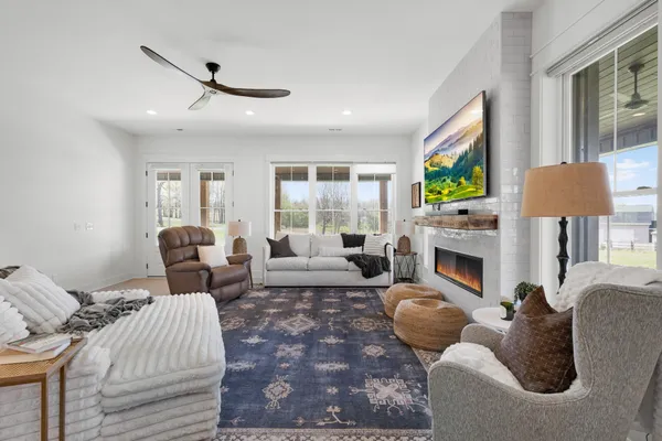 a living room with furniture a fireplace and a flat screen tv
