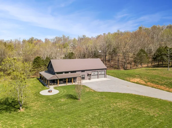 an aerial view of a house with big yard