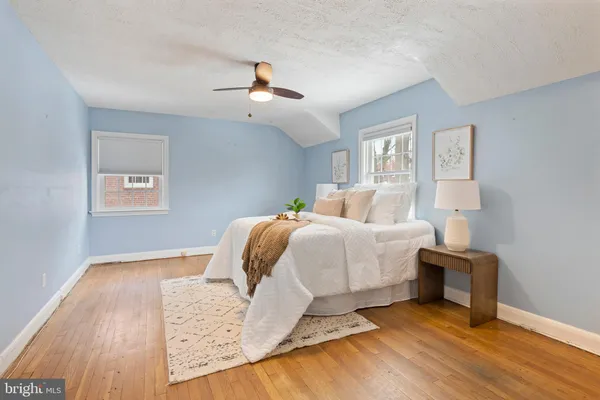 a bedroom with a bed and wooden floor
