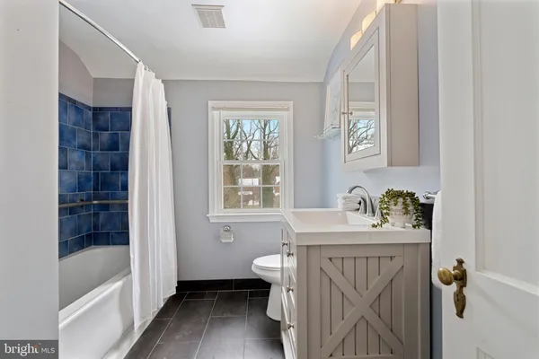 a bathroom with a sink a toilet and a bathtub