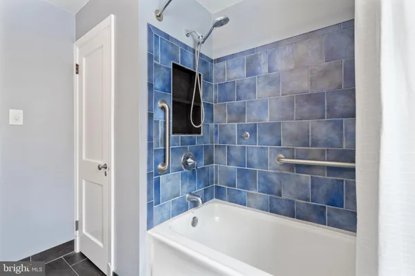 a bathroom with a bathtub and shower