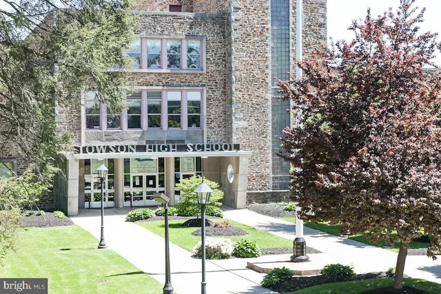 a front view of a building with garden