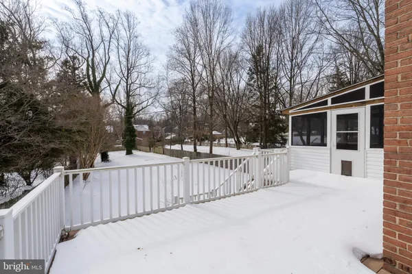 a view of white house with wooden fence