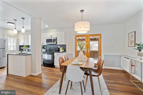a view of a dining room with furniture window and wooden floor