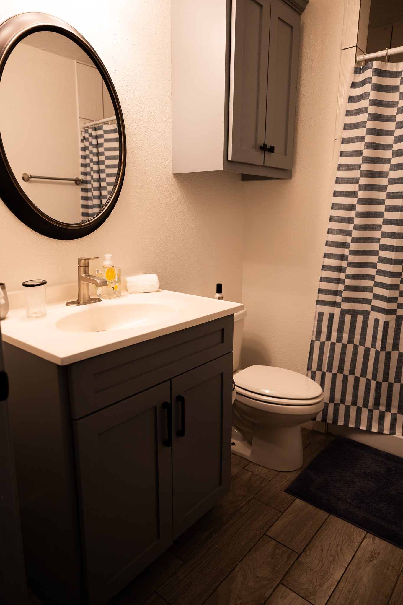 10463 Alcott Drive, Unit B Houston, TX 77043 - Photo 11 of 11 a bathroom with a toilet a sink and a mirror