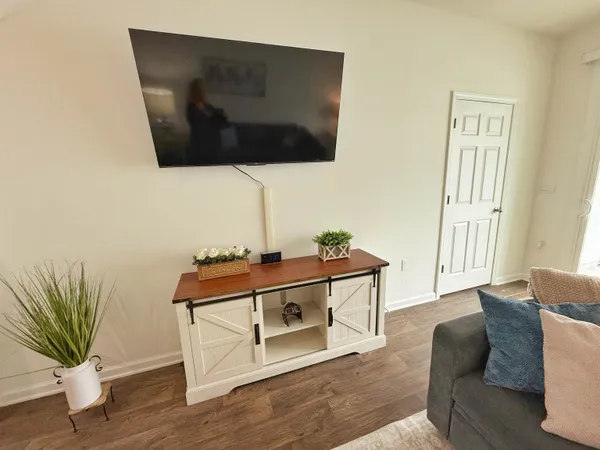 a living room with furniture and a flat screen tv