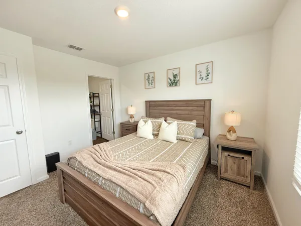 a bedroom with a bed and a night stand