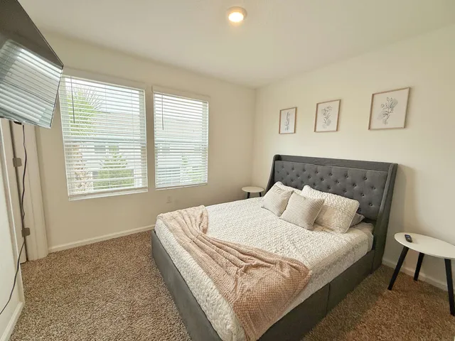 a bedroom with a bed and a couch