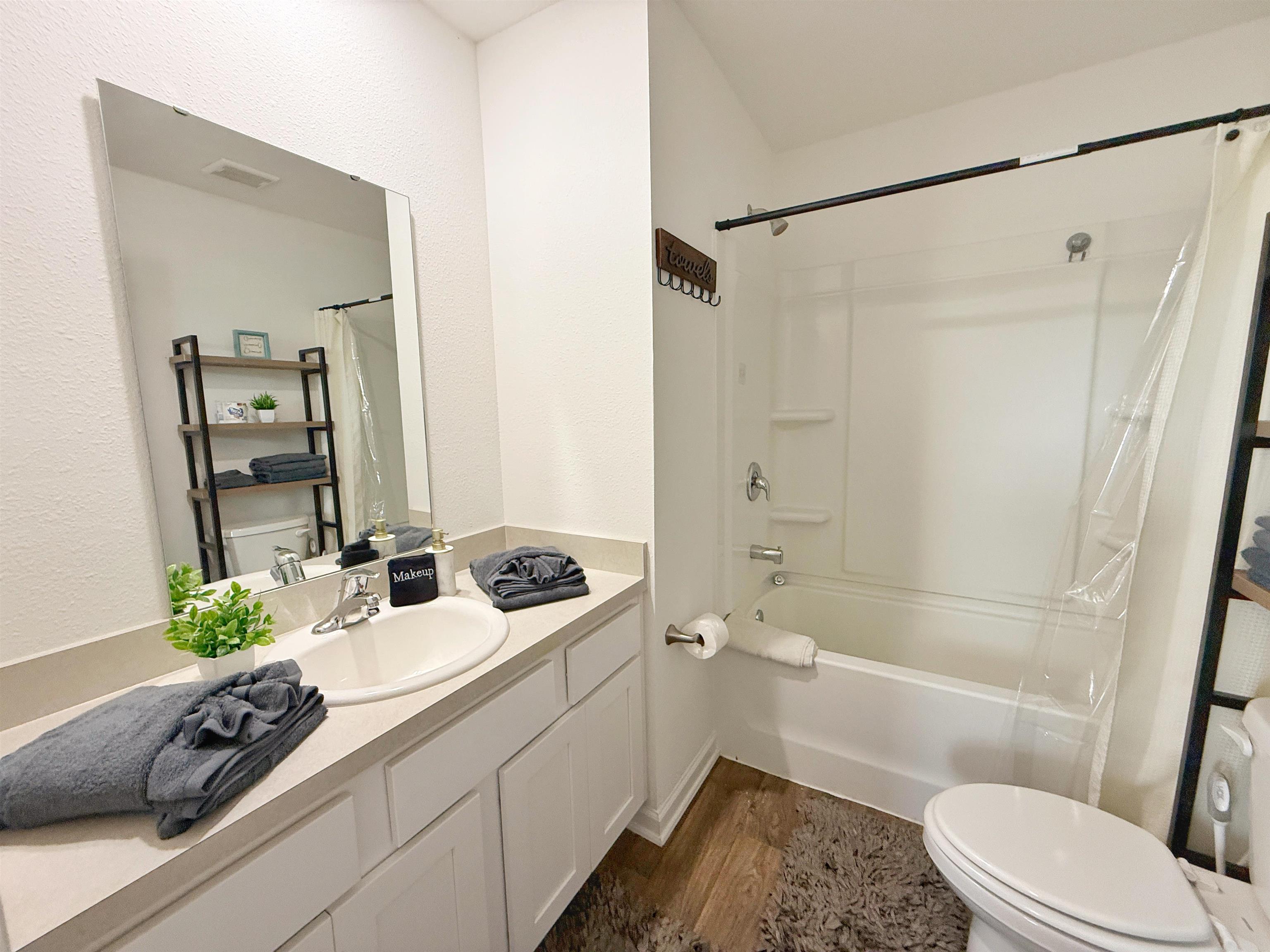 98 Vidalia Ridge Rd Street St. Augustine, FL 32084 - Photo 23 of 26 a bathroom with a sink a mirror a toilet and shower
