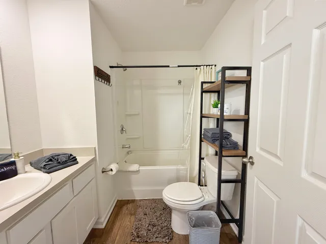 a bathroom with a sink toilet and shower
