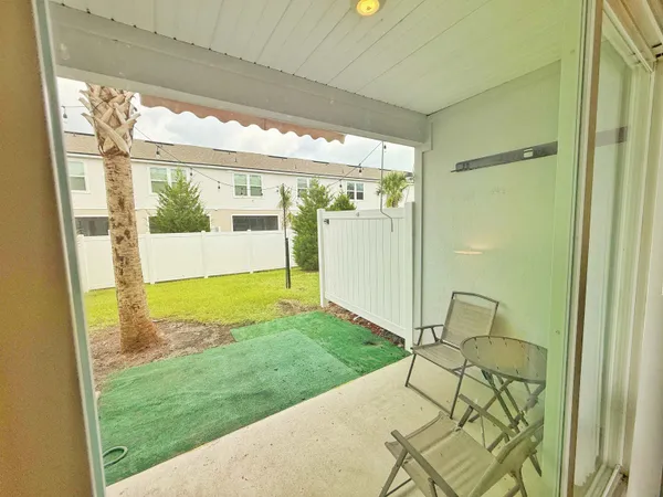a view of a porch with chairs and backyard