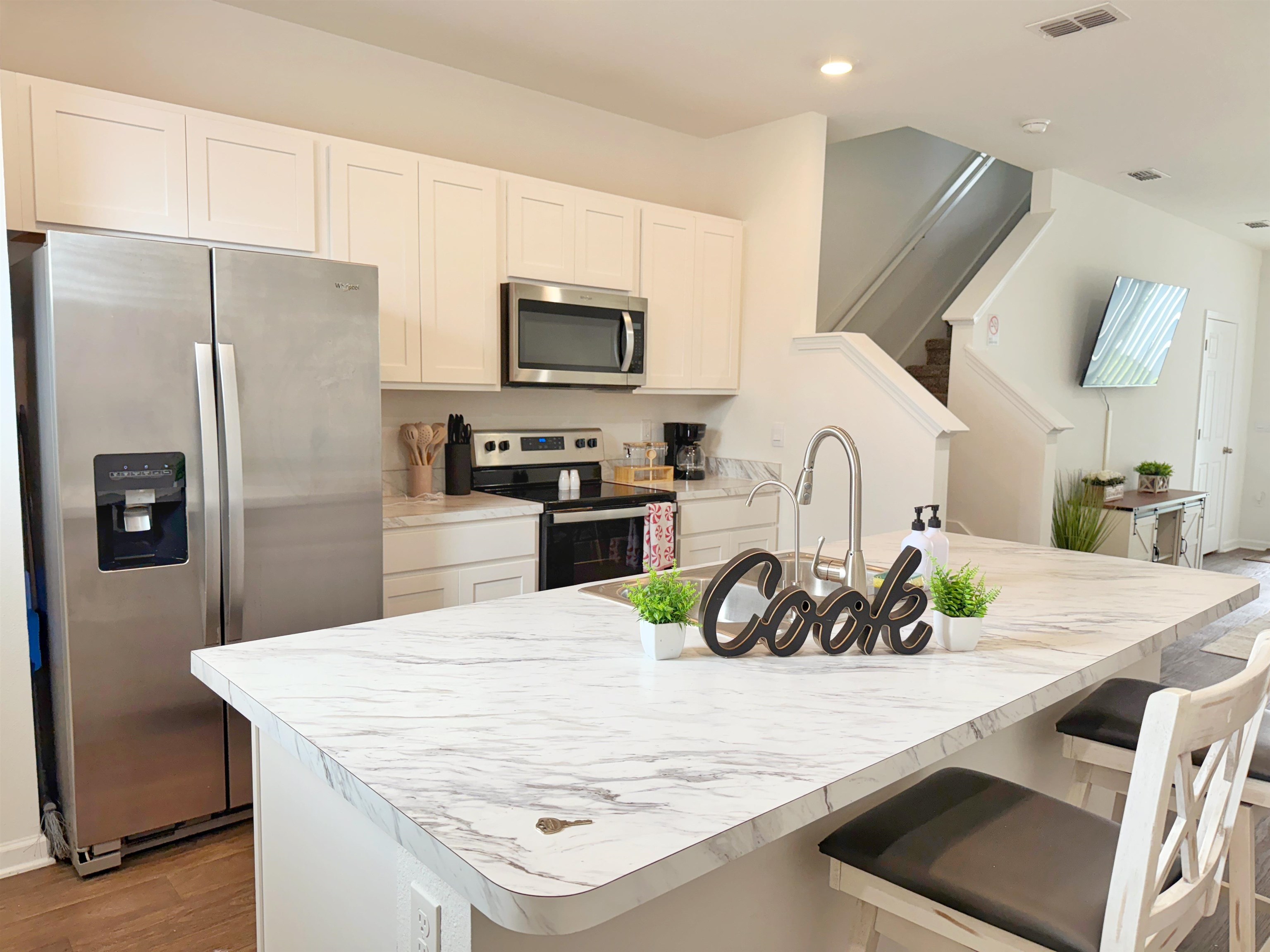 98 Vidalia Ridge Rd Street St. Augustine, FL 32084 - Photo 3 of 26 a kitchen with stainless steel appliances a sink a microwave a refrigerator a stove and white cabinets