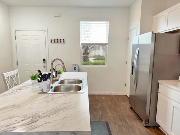 a kitchen with a refrigerator sink and cabinets