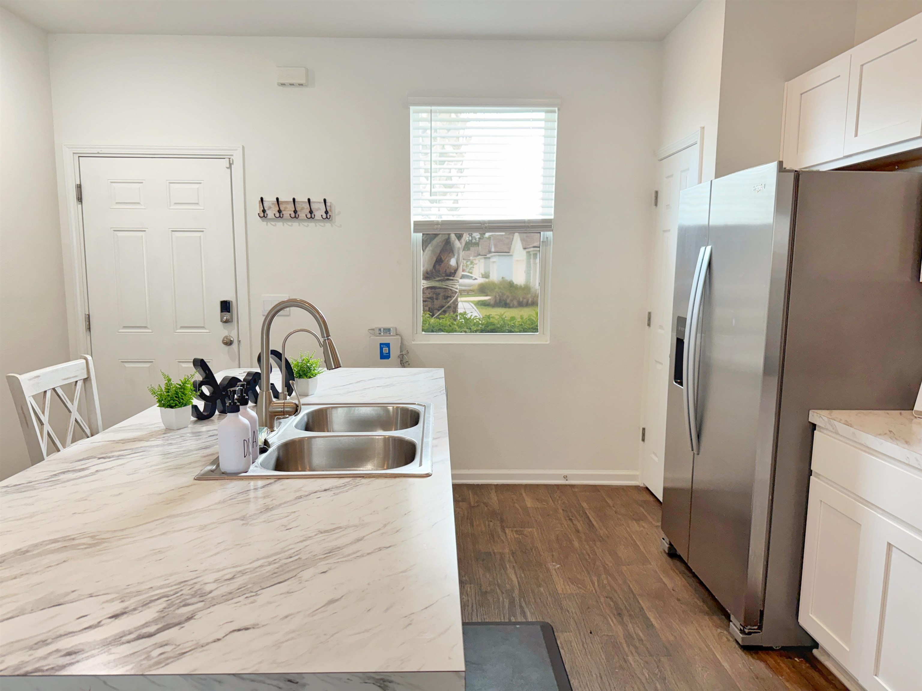 98 Vidalia Ridge Rd Street St. Augustine, FL 32084 - Photo 6 of 26 a kitchen with a refrigerator sink and cabinets