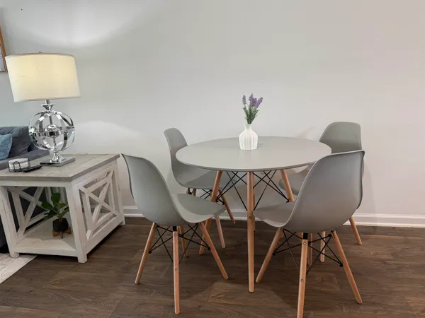 a view of a dining room with furniture and wooden floor