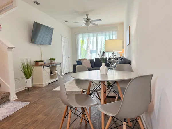 a view of a dining room with furniture and wooden floor