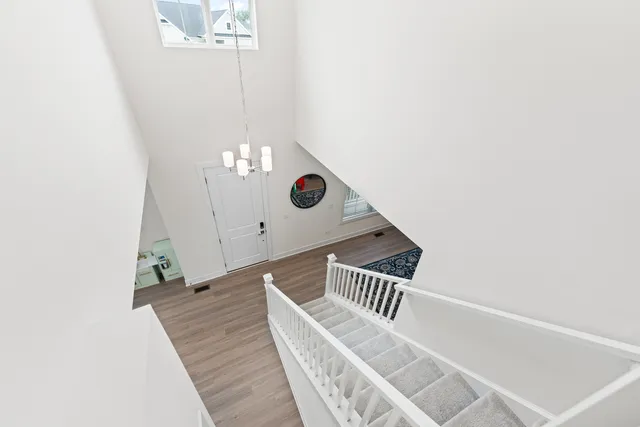 a spacious bathroom with double sink large mirror and next to a window