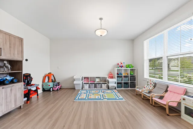 a living room with furniture a rug and a window