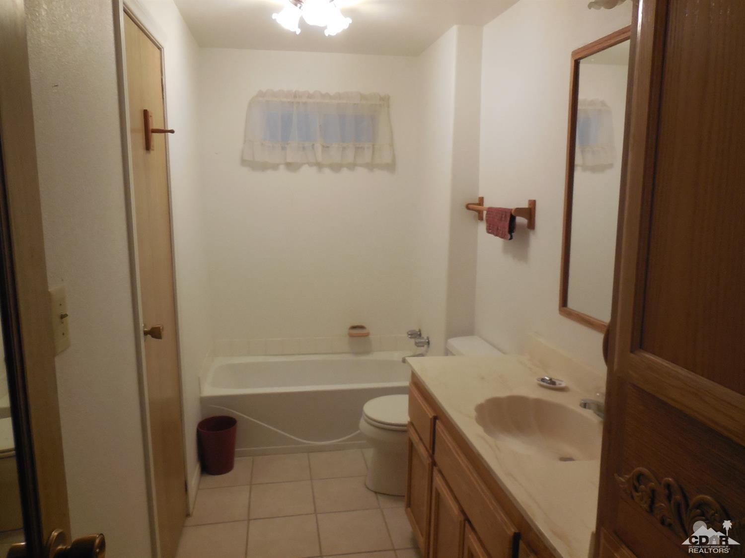 16820 Sunrise Road Desert Hot Springs, CA 92241 - Photo 11 of 19 a bathroom with a sink a toilet and shower
