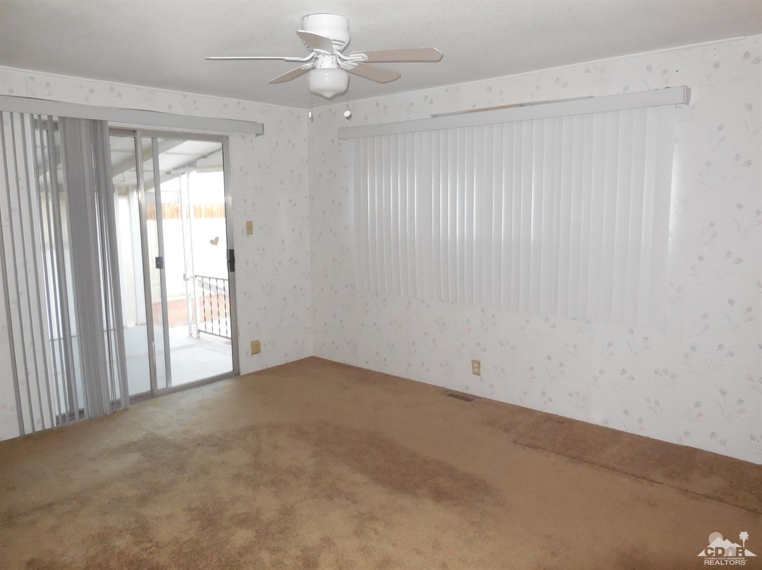 16820 Sunrise Road Desert Hot Springs, CA 92241 - Photo 12 of 19 an empty room with a window and a fan