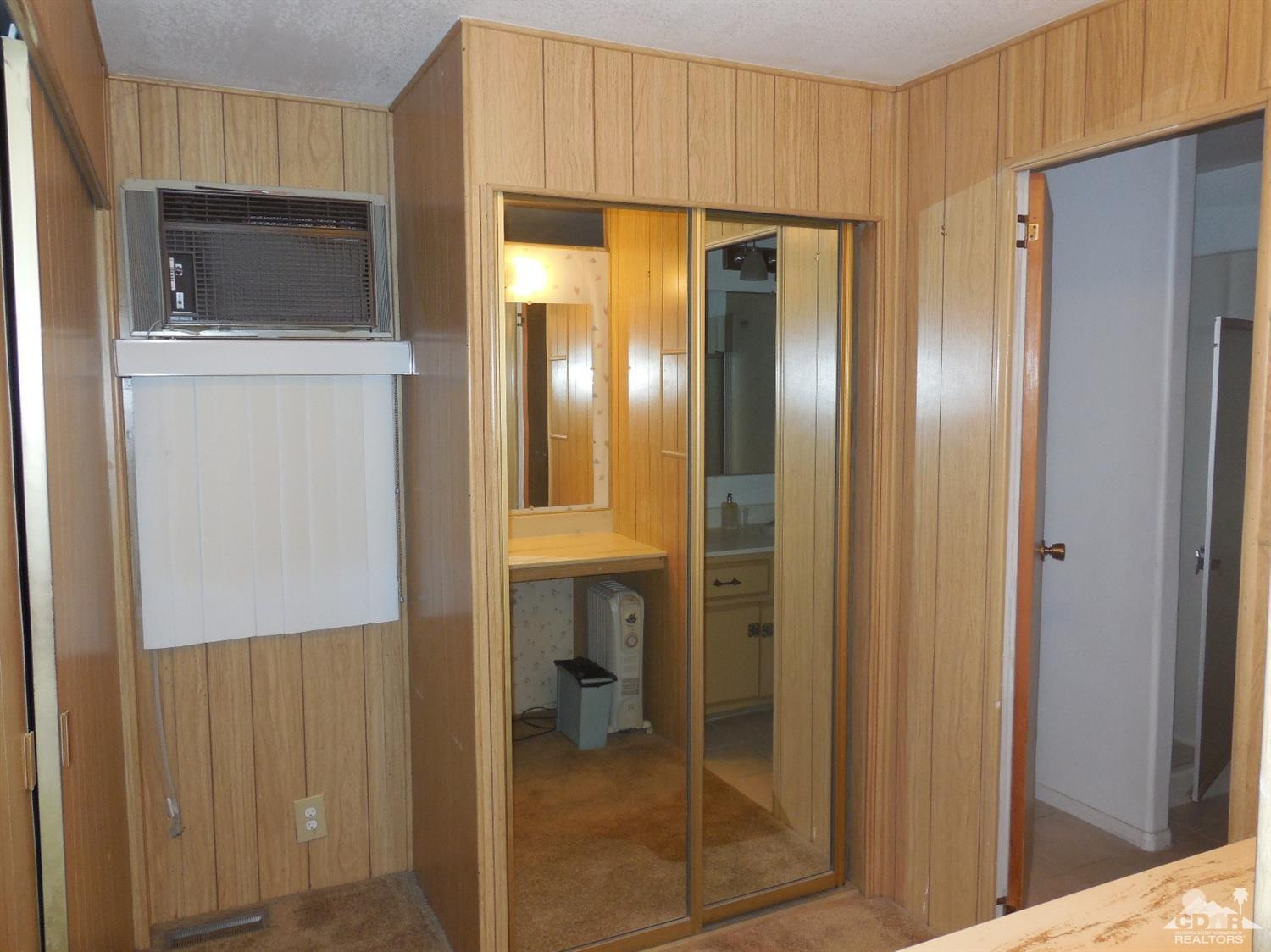16820 Sunrise Road Desert Hot Springs, CA 92241 - Photo 13 of 19 a bathroom with a glass shower door and a sink