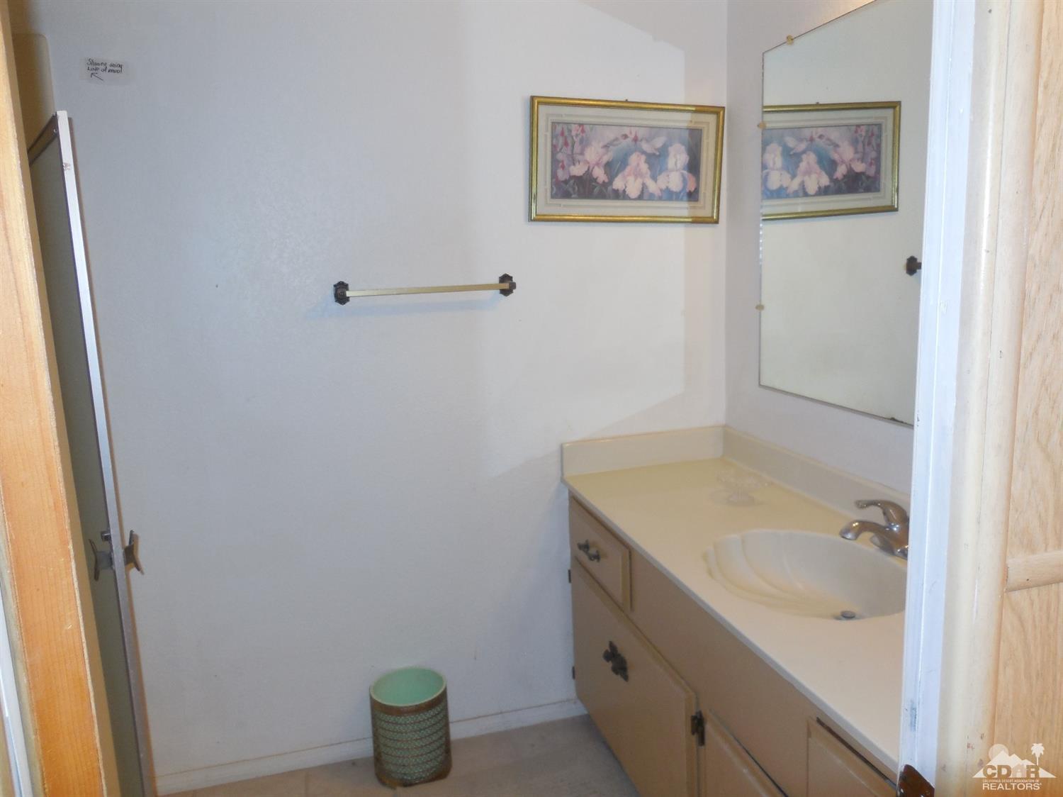 16820 Sunrise Road Desert Hot Springs, CA 92241 - Photo 14 of 19 a bathroom with a sink and a window