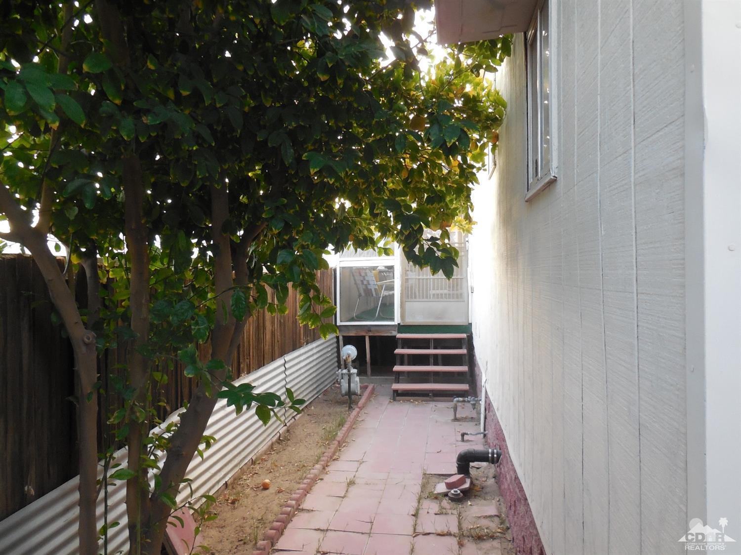 16820 Sunrise Road Desert Hot Springs, CA 92241 - Photo 16 of 19 a view of a house with a backyard