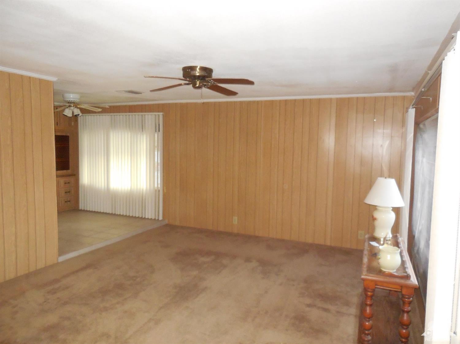 16820 Sunrise Road Desert Hot Springs, CA 92241 - Photo 3 of 19 a view of an empty room and a window