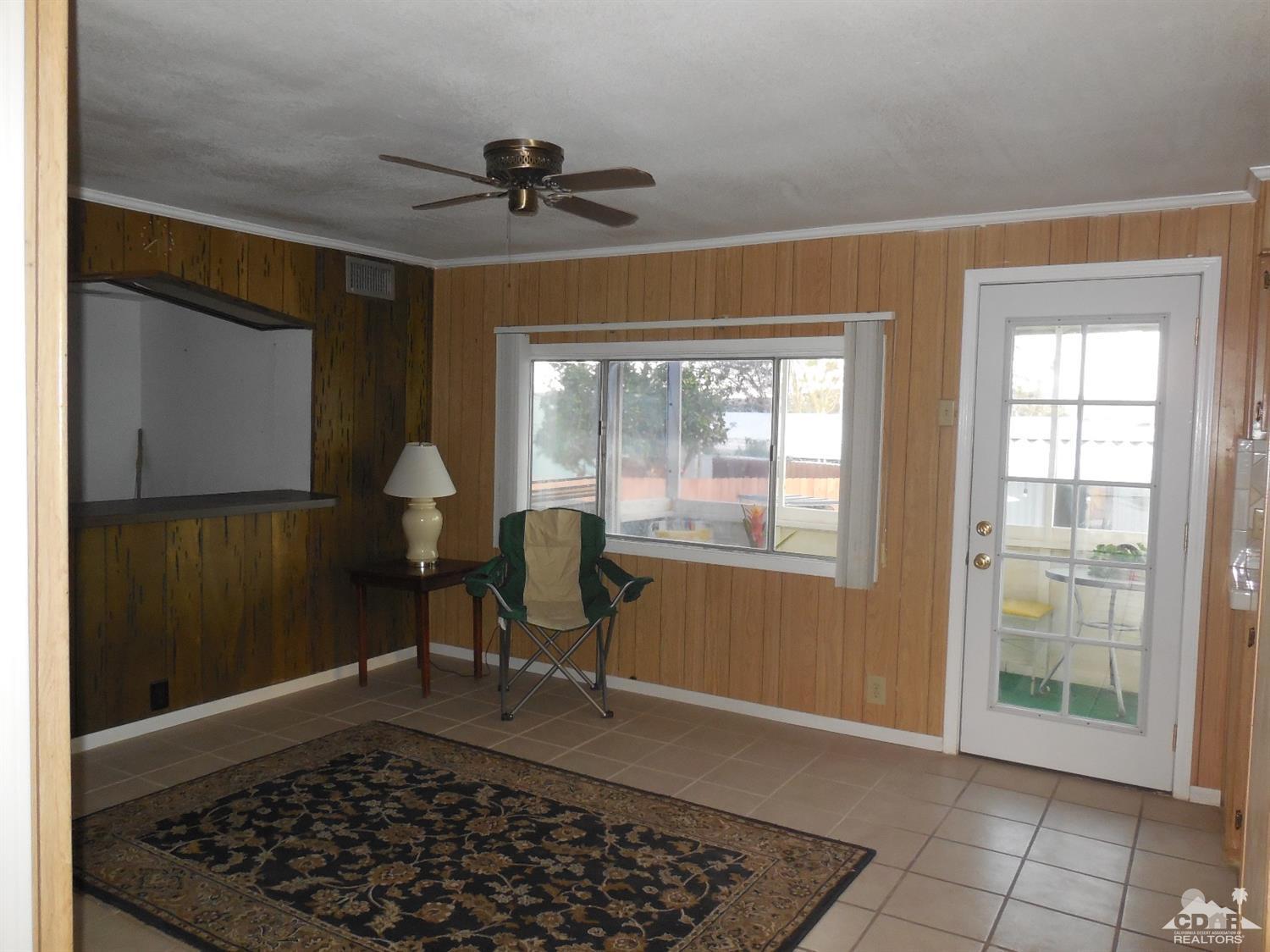 16820 Sunrise Road Desert Hot Springs, CA 92241 - Photo 4 of 19 a view of a livingroom with furniture and windows