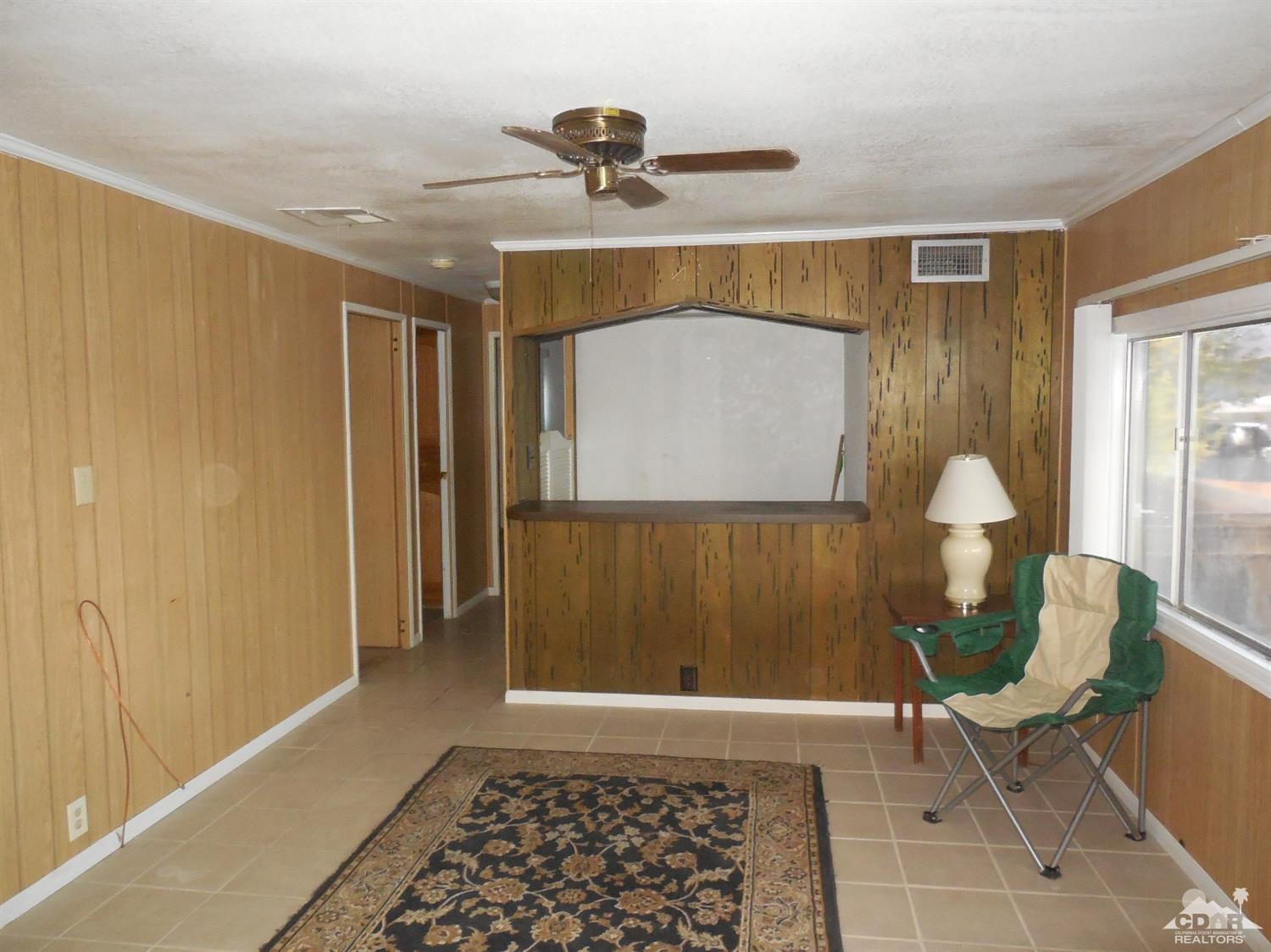 16820 Sunrise Road Desert Hot Springs, CA 92241 - Photo 8 of 19 a living room with a table and a rug