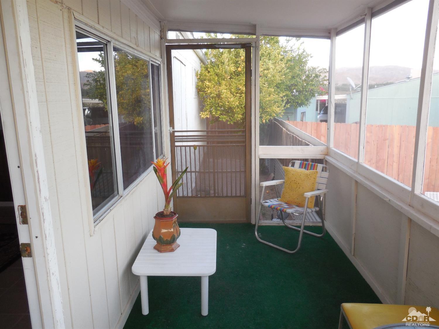 16820 Sunrise Road Desert Hot Springs, CA 92241 - Photo 9 of 19 a living room with furniture and a window