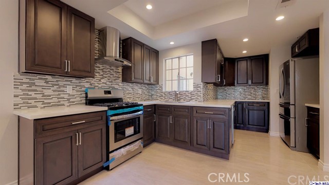 1245 Grandview Avenue, Unit 4 Glendale, CA 91201 - Photo 1 of 20 a kitchen with stainless steel appliances granite countertop wooden cabinets granite counter tops and a stove