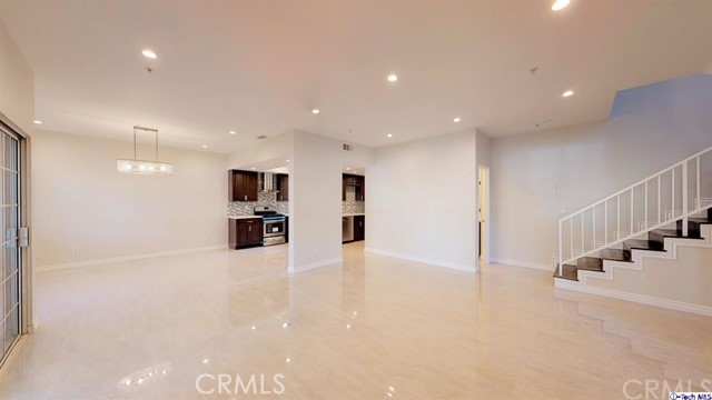 1245 Grandview Avenue, Unit 4 Glendale, CA 91201 - Photo 3 of 20 a view of an empty room with stairs and a kitchen view