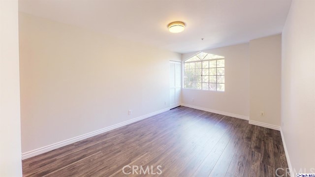 1245 Grandview Avenue, Unit 4 Glendale, CA 91201 - Photo 9 of 20 an empty room with wooden floor and windows