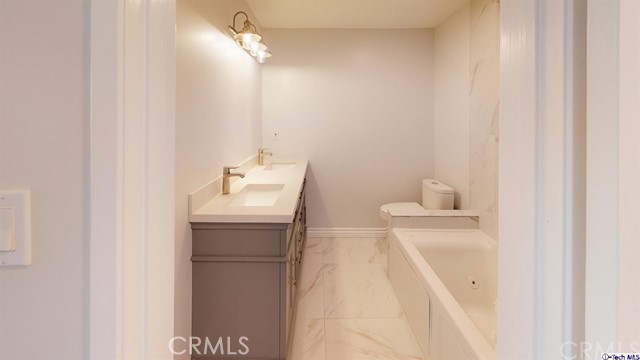 1245 Grandview Avenue, Unit 4 Glendale, CA 91201 - Photo 10 of 20 a bathroom with a sink a toilet and a mirror