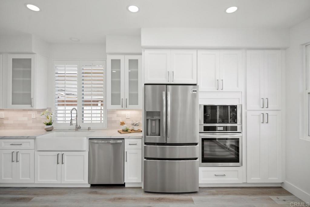 6160 Paseo Tapajos Carlsbad, CA 92009 - Photo 11 of 28 a kitchen with appliances a sink and a window
