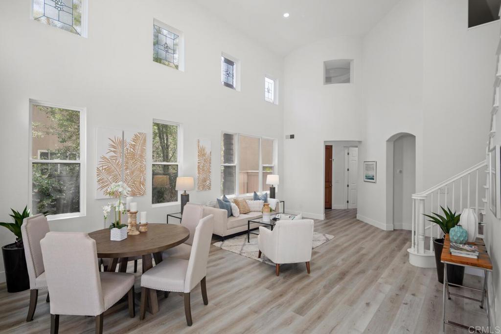 6160 Paseo Tapajos Carlsbad, CA 92009 - Photo 15 of 28 a living room with furniture a wooden floor and a large window