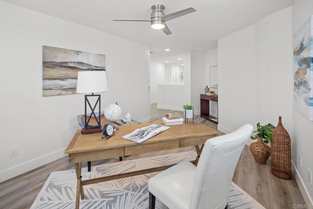 6160 Paseo Tapajos Carlsbad, CA 92009 - Photo 16 of 28 a living room with furniture and a wooden floor