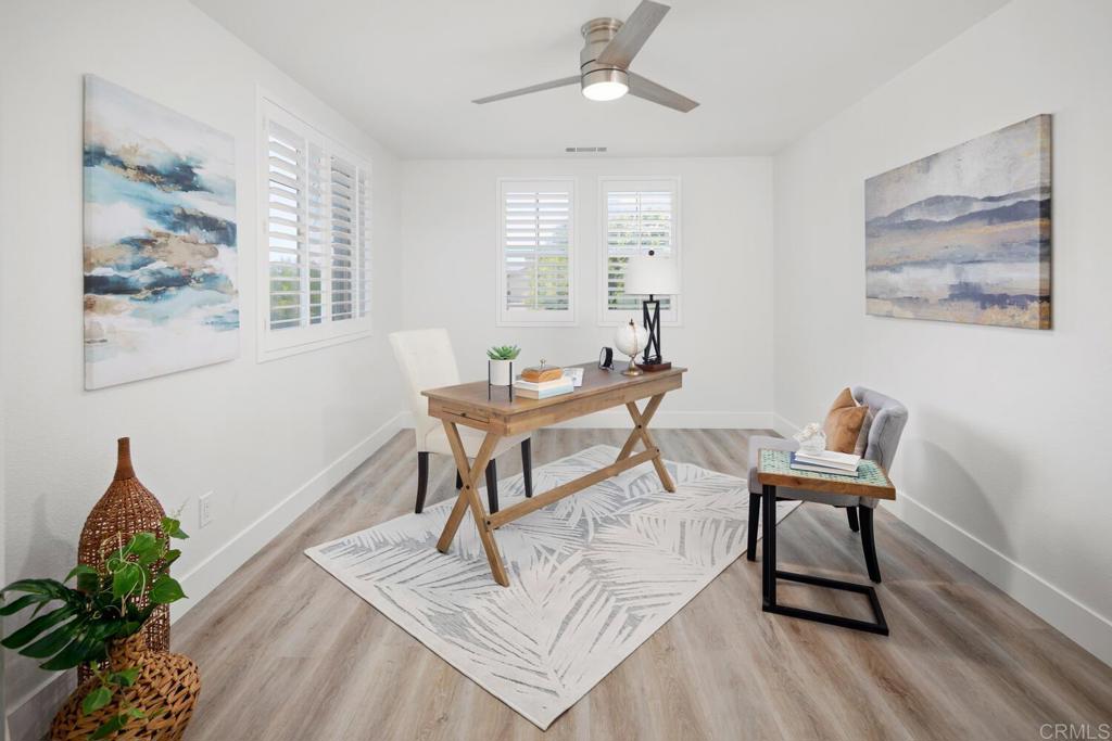 6160 Paseo Tapajos Carlsbad, CA 92009 - Photo 18 of 28 a living room with furniture a window and wooden floor