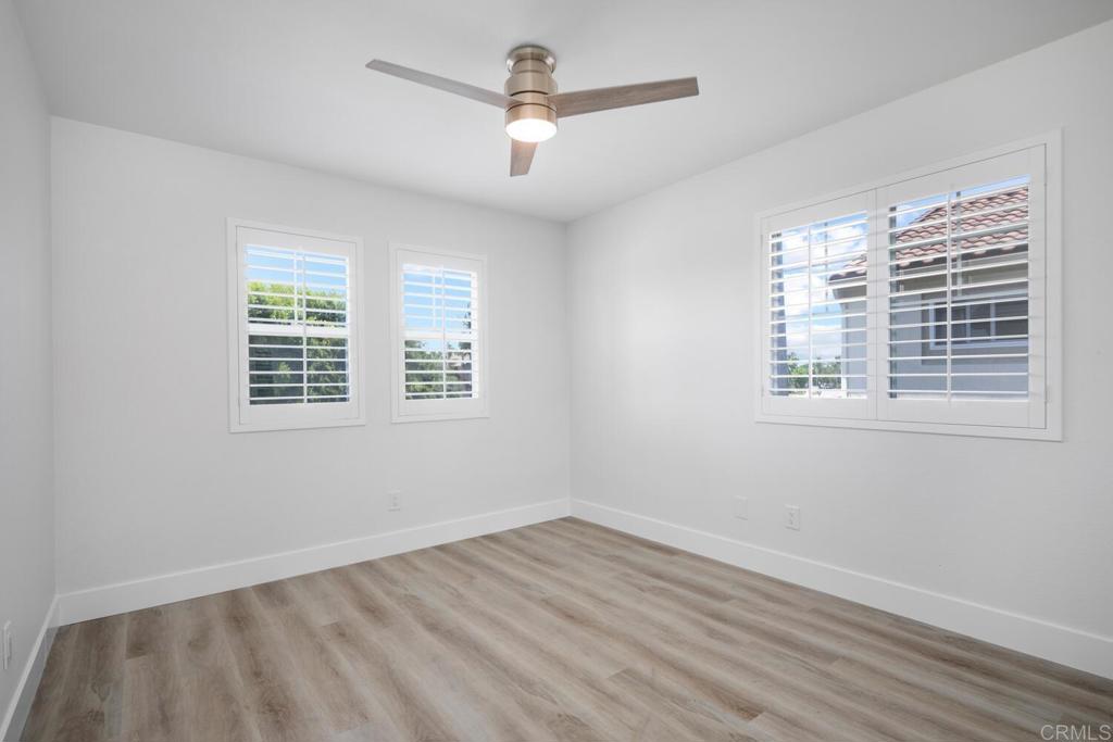 6160 Paseo Tapajos Carlsbad, CA 92009 - Photo 19 of 28 a view of an empty room with wooden floor and a window