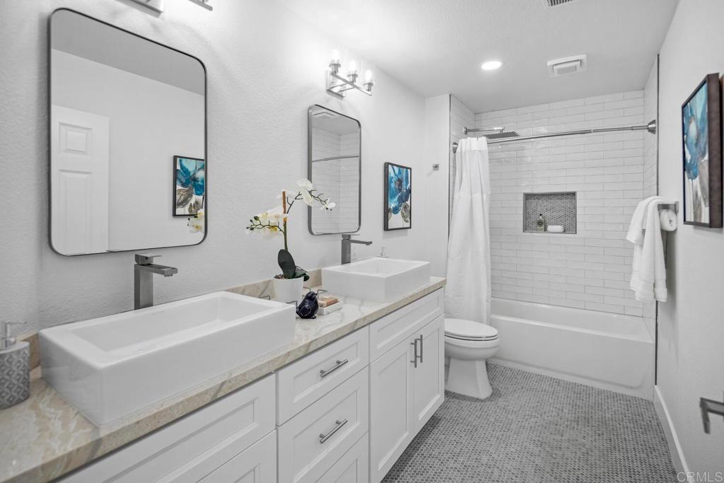 6160 Paseo Tapajos Carlsbad, CA 92009 - Photo 21 of 28 a bathroom with a double vanity sink toilet mirror and shower