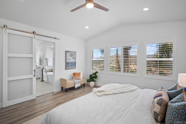 a spacious bedroom with a bed and furniture