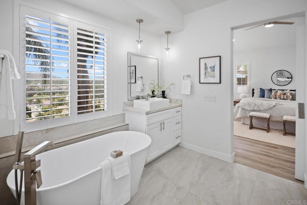 6160 Paseo Tapajos Carlsbad, CA 92009 - Photo 24 of 28 a bathroom with a tub sink and mirror