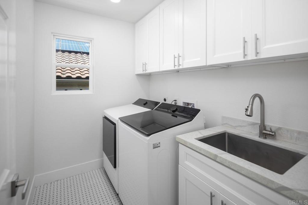 6160 Paseo Tapajos Carlsbad, CA 92009 - Photo 26 of 28 a view of a kitchen with sink and washing machine