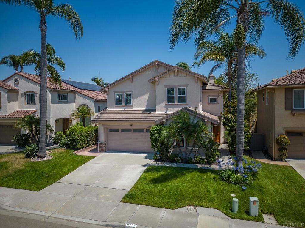 6160 Paseo Tapajos Carlsbad, CA 92009 - Photo 3 of 28 a front view of a house with a garden and trees