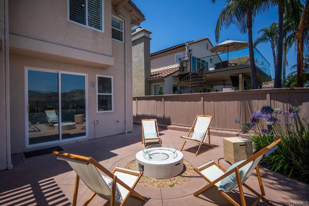 6160 Paseo Tapajos Carlsbad, CA 92009 - Photo 5 of 28 a view of a patio with table and chairs potted plants and palm tree